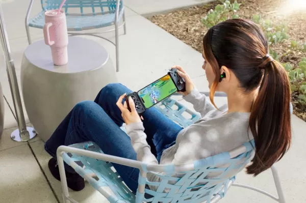 a girl on a chair playing genshin impact on the razer kishi v3 pro controller